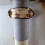 Picture of pipe wrap repair of vertical piping along side of a tank